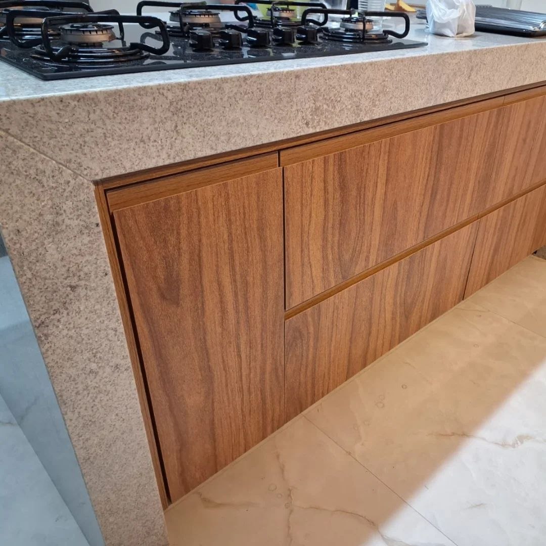 Detalhe de bancada de granito e armários planejados em madeira na cozinha — Mollo Art
